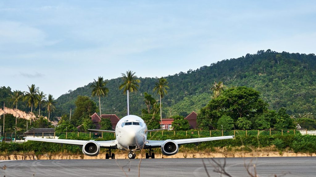 Un avion atterrit à l’aéroport international de Bali, illustrant l’arrivée des voyageurs sur l’île indonésienne.