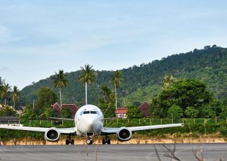 Un avion atterrit à l’aéroport international de Bali, illustrant l’arrivée des voyageurs sur l’île indonésienne.
